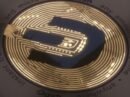 Close-up view of Dash cryptocurrency coins arranged in a pattern with dramatic lighting.